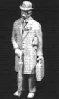 Man wearing bowler & overcoat, with umbrella 