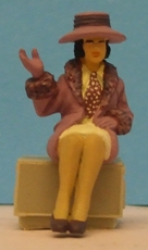 Omen - Seated lady wearing a fur-trimmed coat, right hand raised