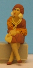 Omen - Seated woman wearing a boa & leaning forward