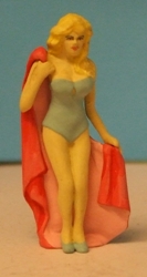 Omen - Girl in one piece swim-suit, holding a towel behind her back