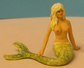 Omen - Mermaid seated with her tail to one side